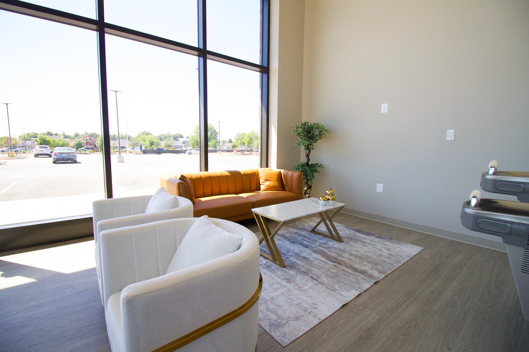 Comfortable waiting area with leather seating and floor-to-ceiling windows